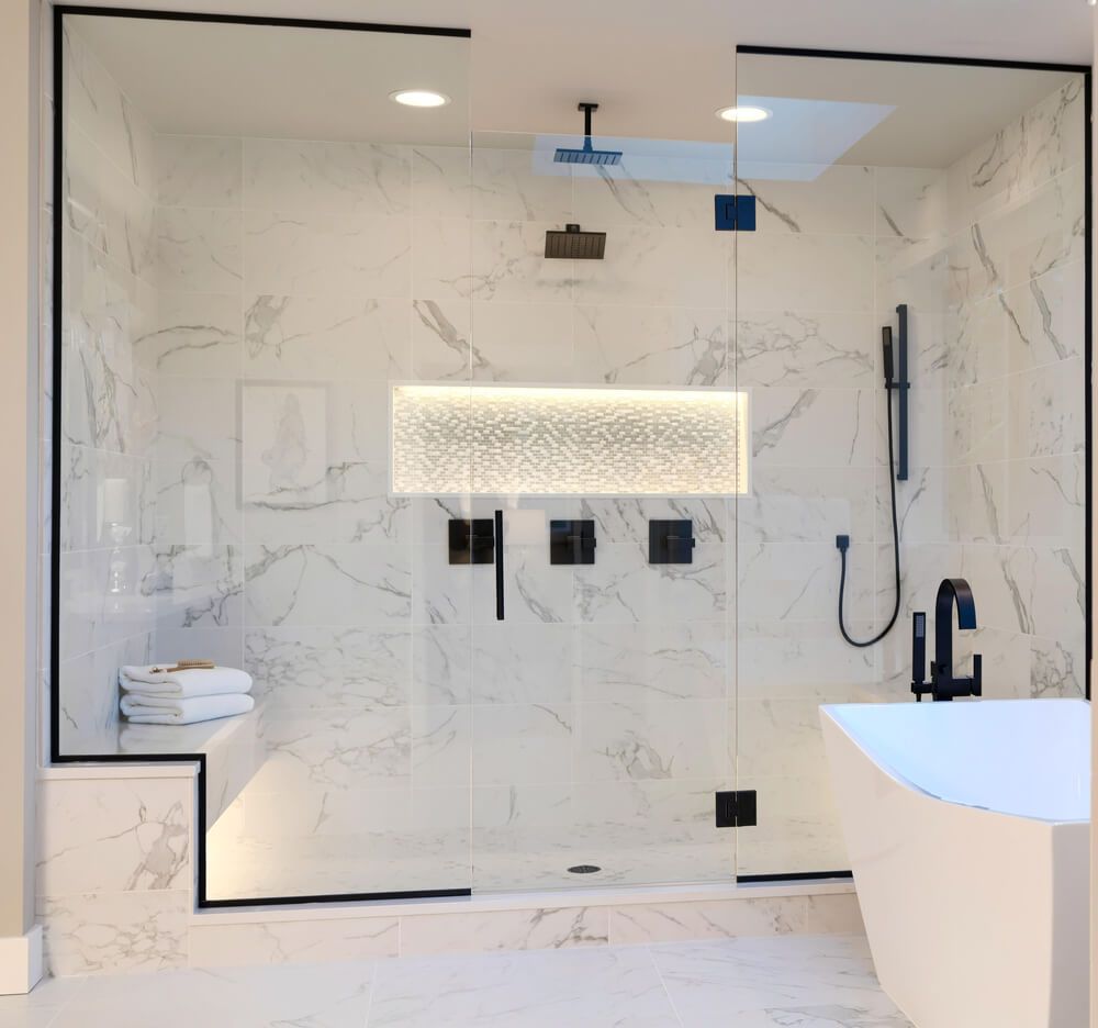 luxury master bath with marble tiles in shower and flooring