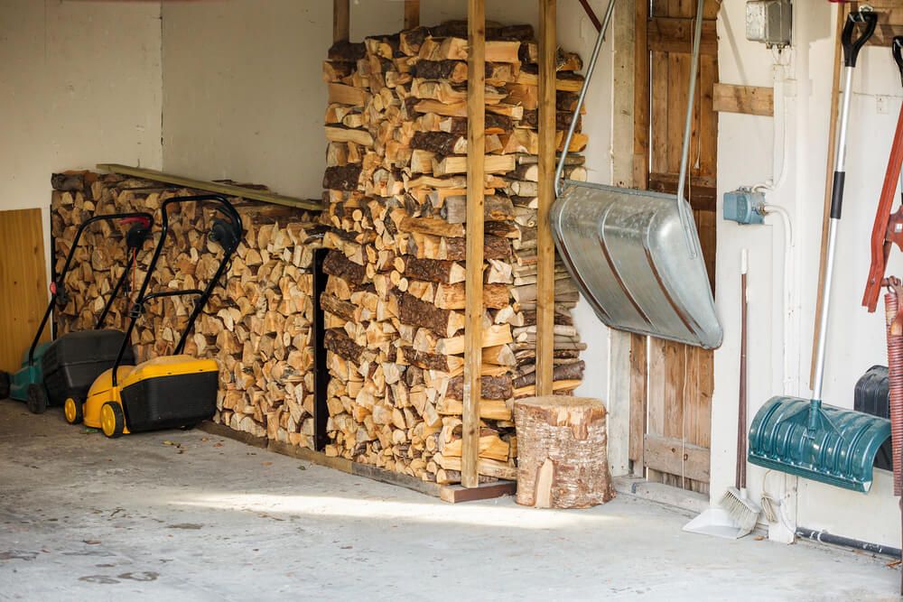 Piles of wood stacked neatly against a garage wall