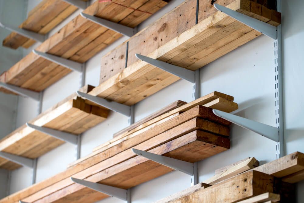 Wooden planks neatly piled on shelves