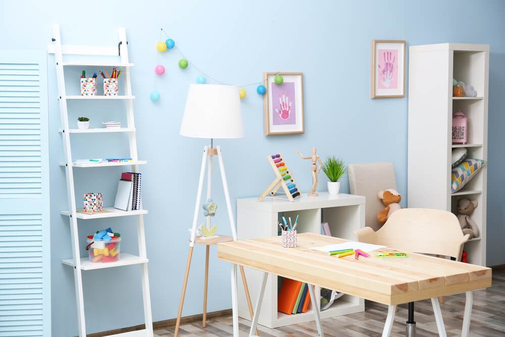 Kids studay room with a desk, lamp and drawers for storage