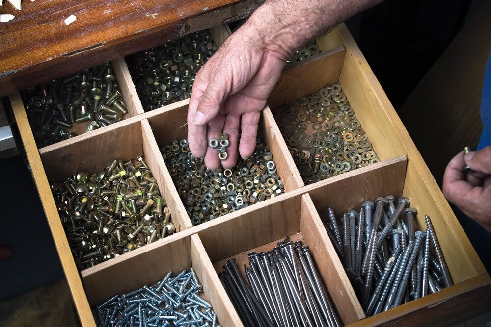 A drawer with dividers for nails, screws, bolts and nuts
