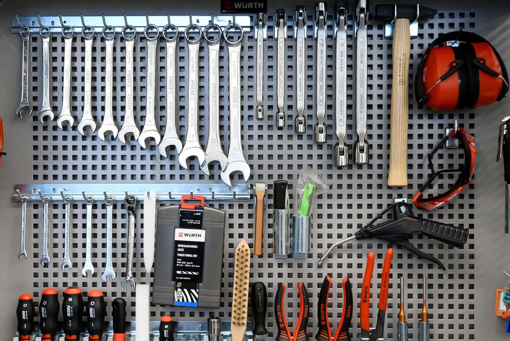 Neatly orgnized tools by size on a pegboard