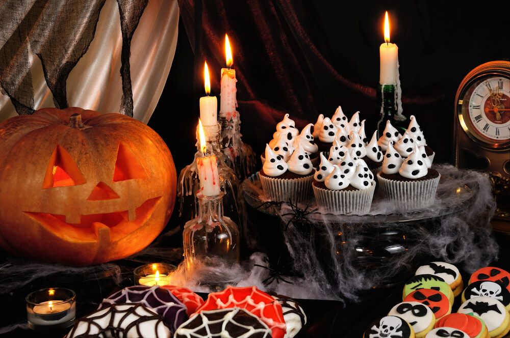 Chocolate muffin meringues with meringues on the table in honor of Halloween
