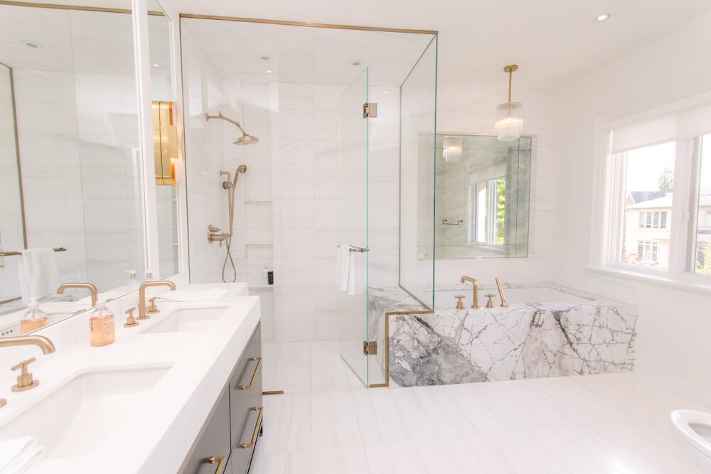 white modern bathroom design with gold accents