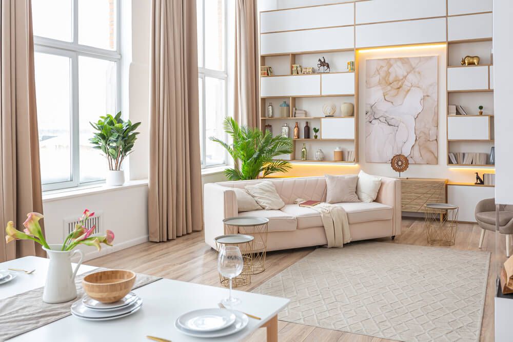A spacious bright studio apartment with warm pastel and beige colors