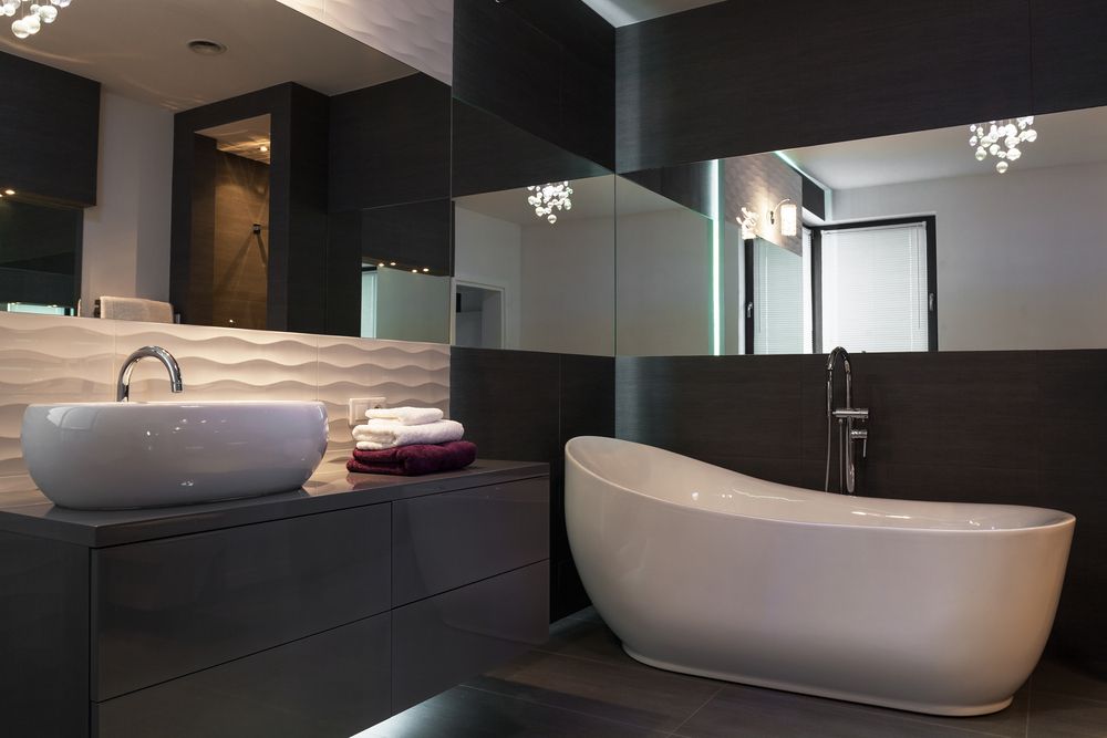 dark bathroom design with white tub and sink