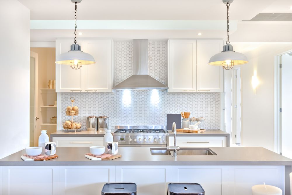 White kitchen with mosaic backsplash and kitchen island