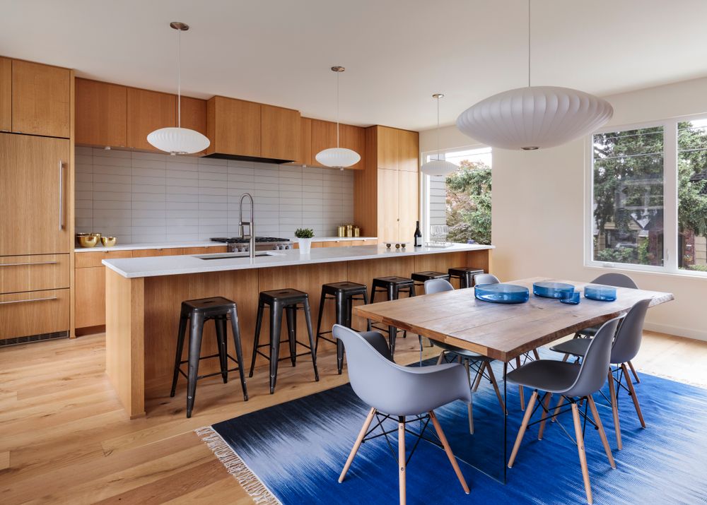 Mid-century modern kitchen with custom wood cabinets and blue accents