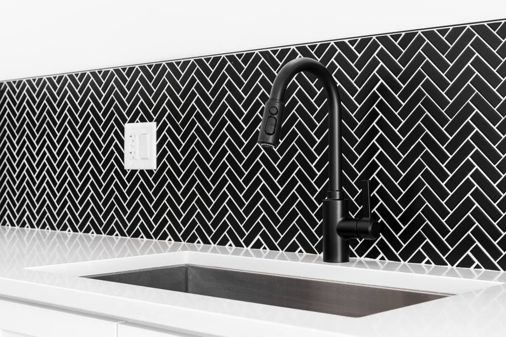 Kitchen black and white herringbone tile backsplash