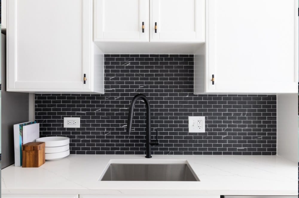 Kitchen white cabinets, small black marble subway tile backsplash