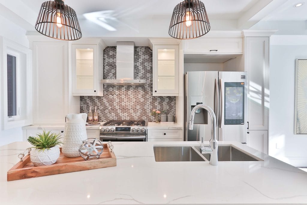 white kitchen with gray and white mosaic tile backsplash