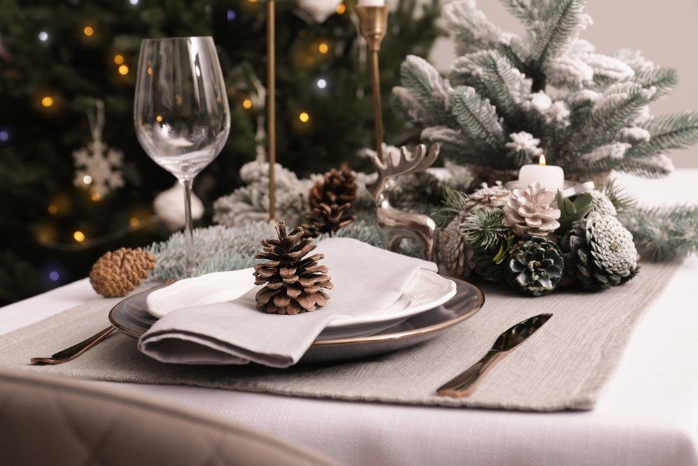 Luxury place setting with beautiful festive decor for Christmas dinner on white table