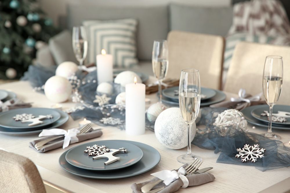 Belle table avec des décorations de Noël blanches et gris clair 