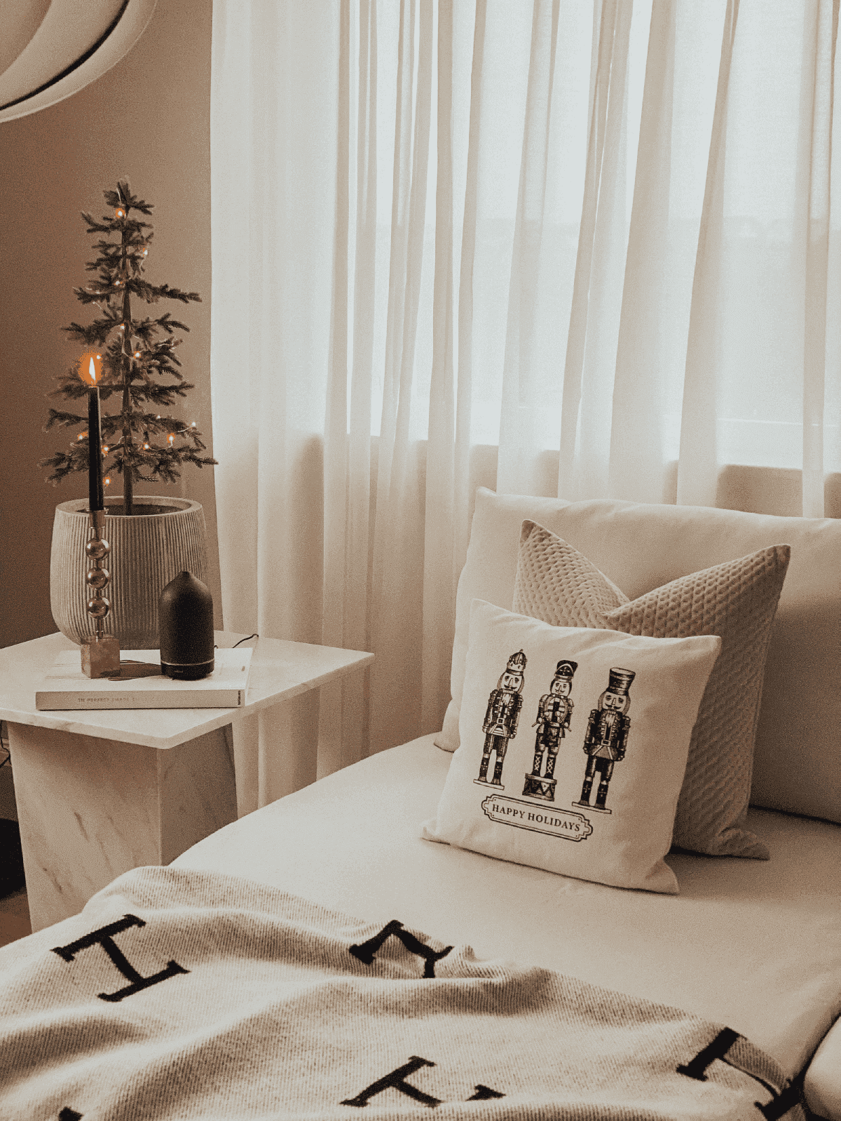 cama com cobertor Hermès e almofadas natalinas com árvore de Natal: ideias de presentes de design