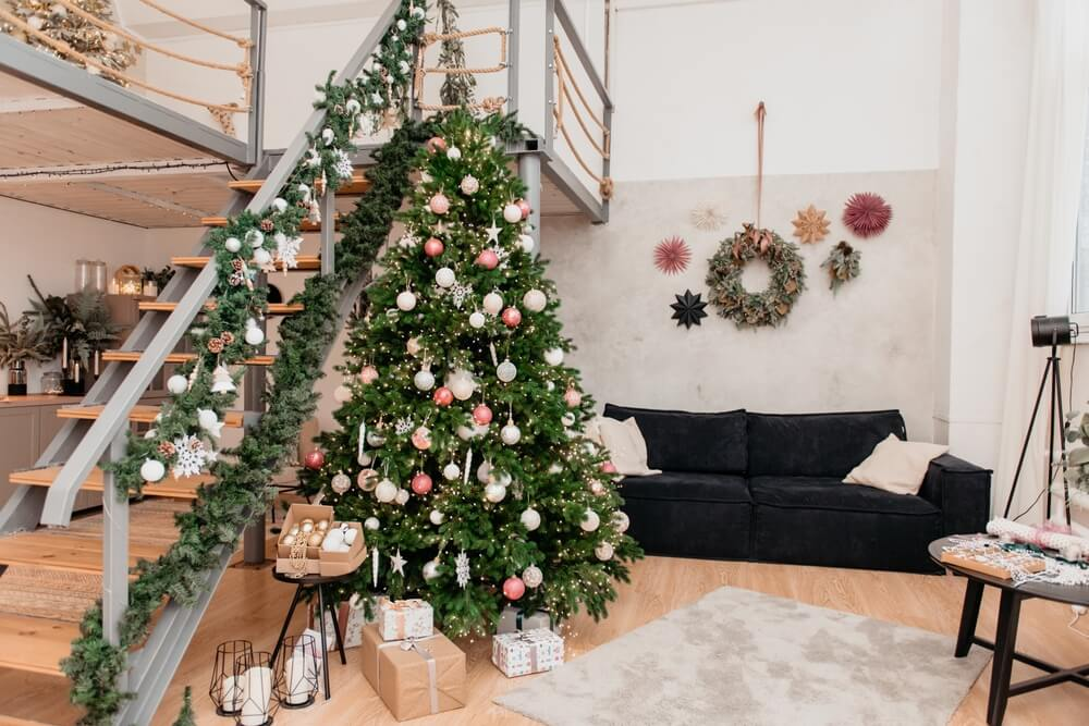 christmas tree and staircase decorated with garlands