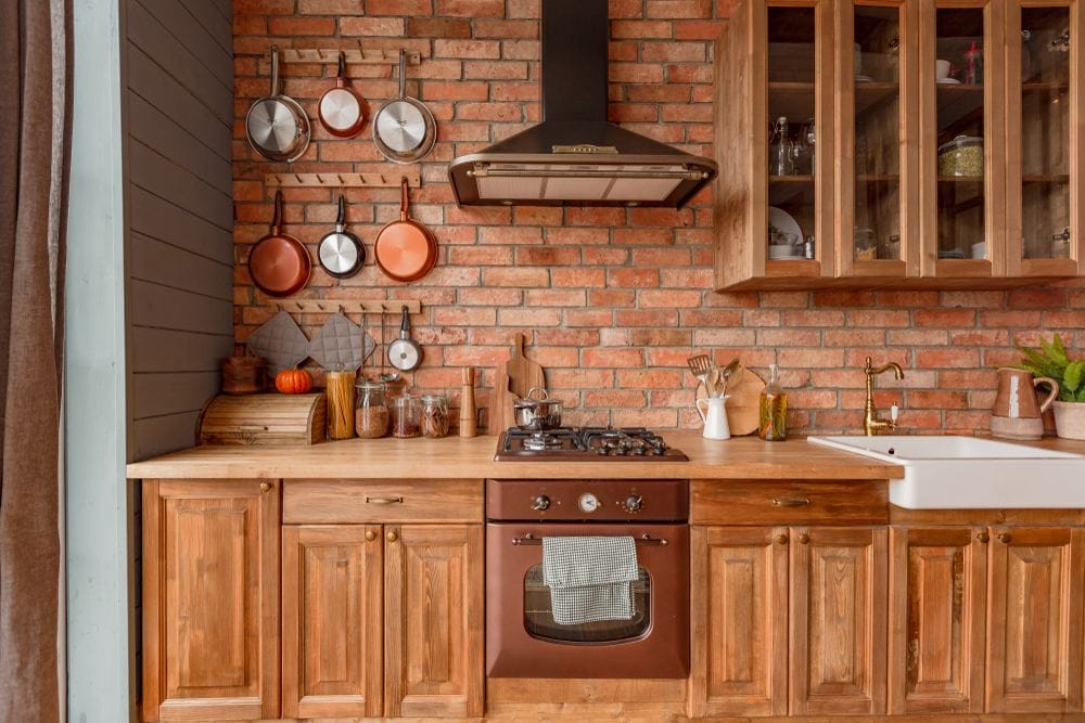rustic kitchen with a brick wall