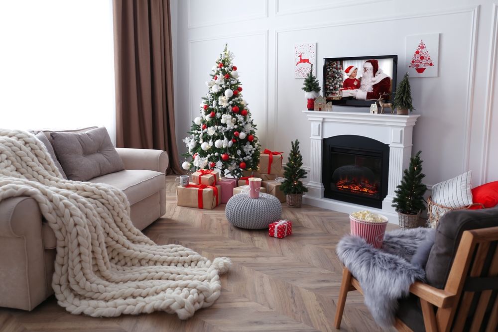 living room with christmas tree and holiday accents