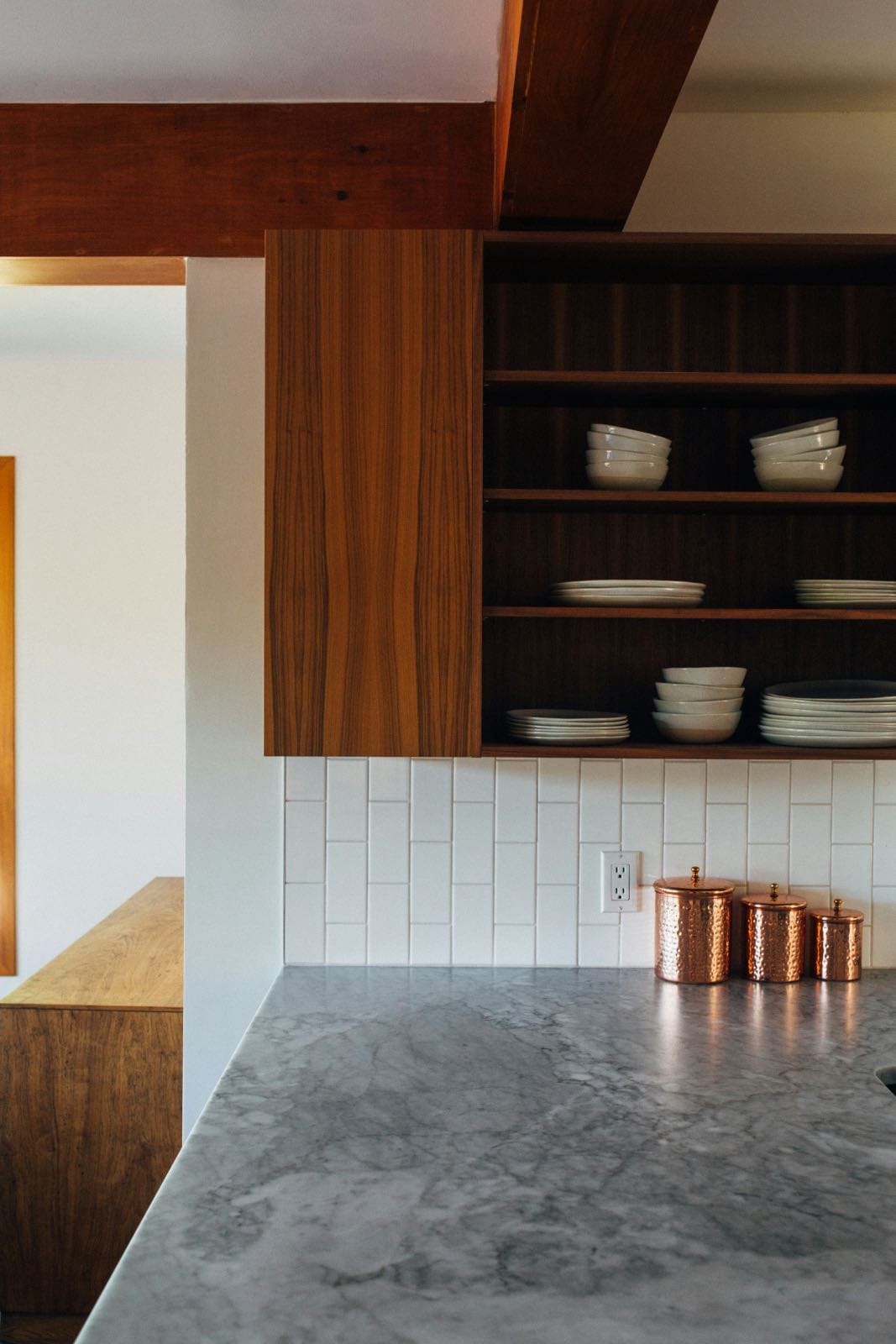 cocina moderna rústica con mármol, azulejos blancos y armarios de madera