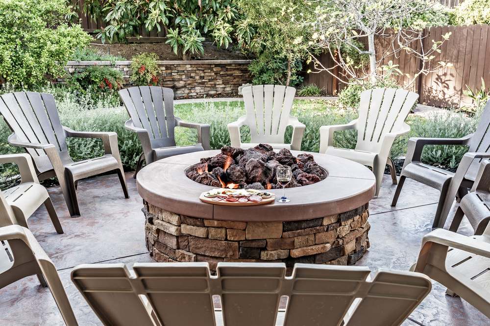 Large outdoor fire pit surrounded by chairs