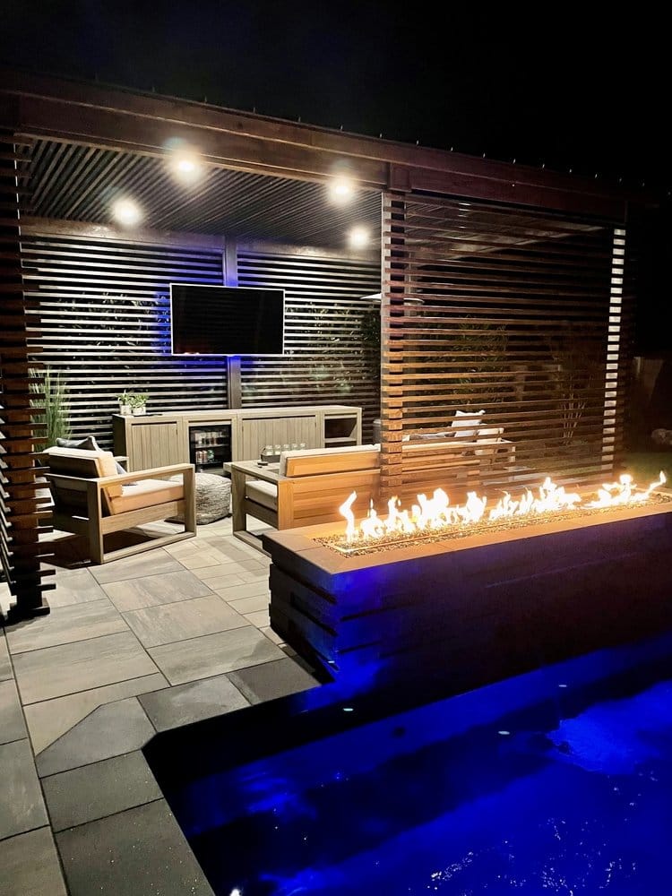 All season stunning outdoor, poolside pergola pavilion at night fully furnished with space to entertain