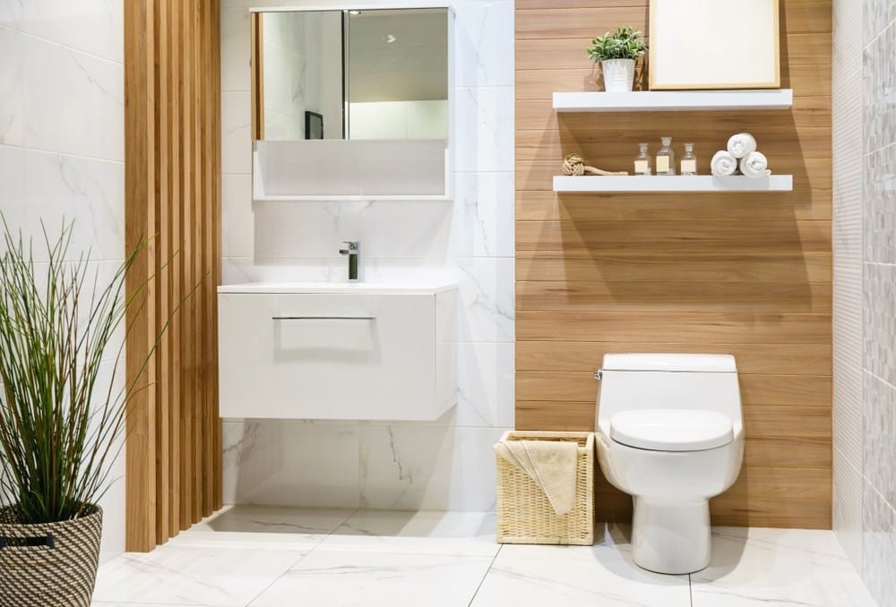 Modern spacious bathroom with bright tiles with toilet and sink