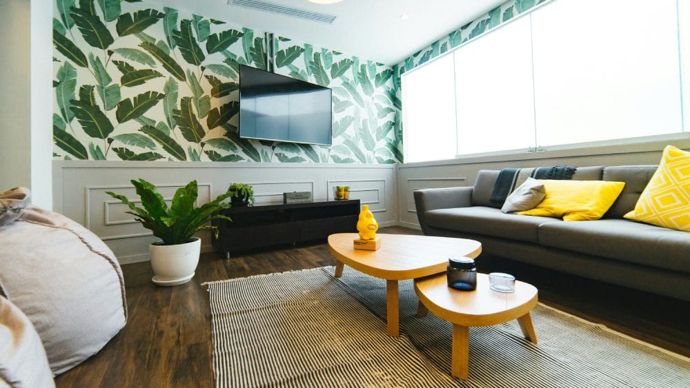 modern living room with a green and white wallpaper and large windows