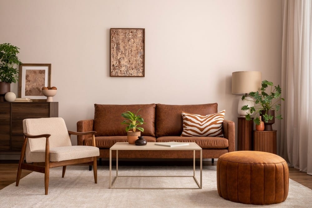 brown couch with a round puff and arm chair 