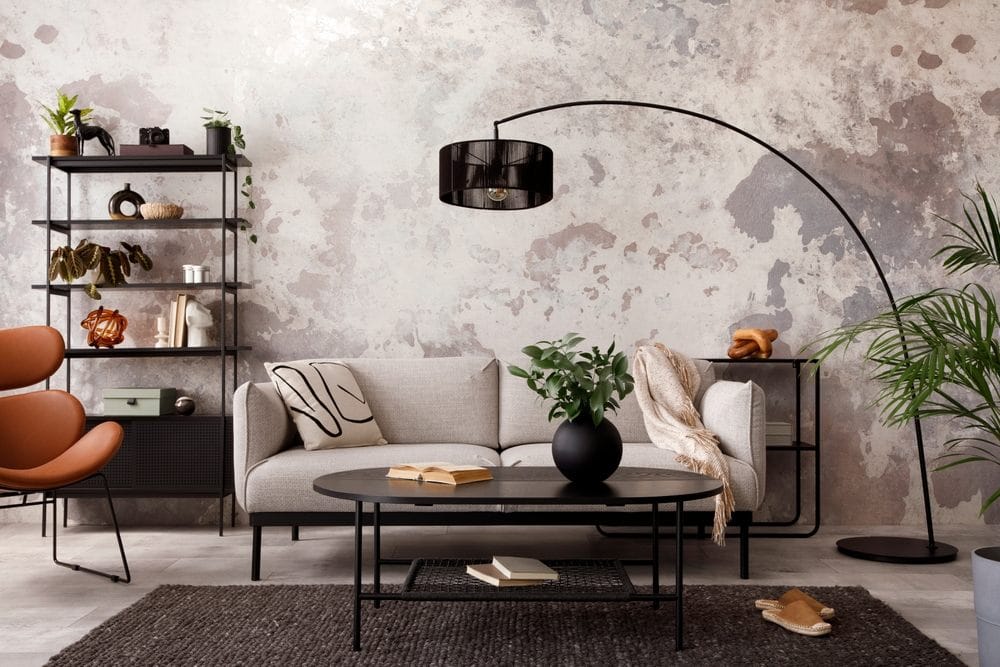 living room with design gray sofa, armchair, black coffee table, lamp 