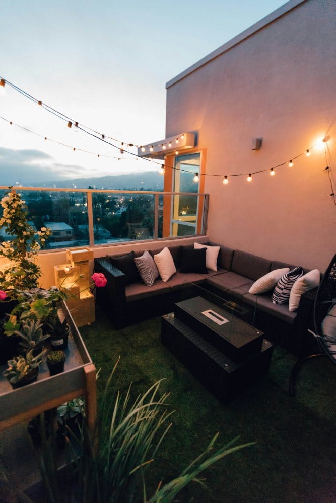 balcony terrace with seating area and sting lights