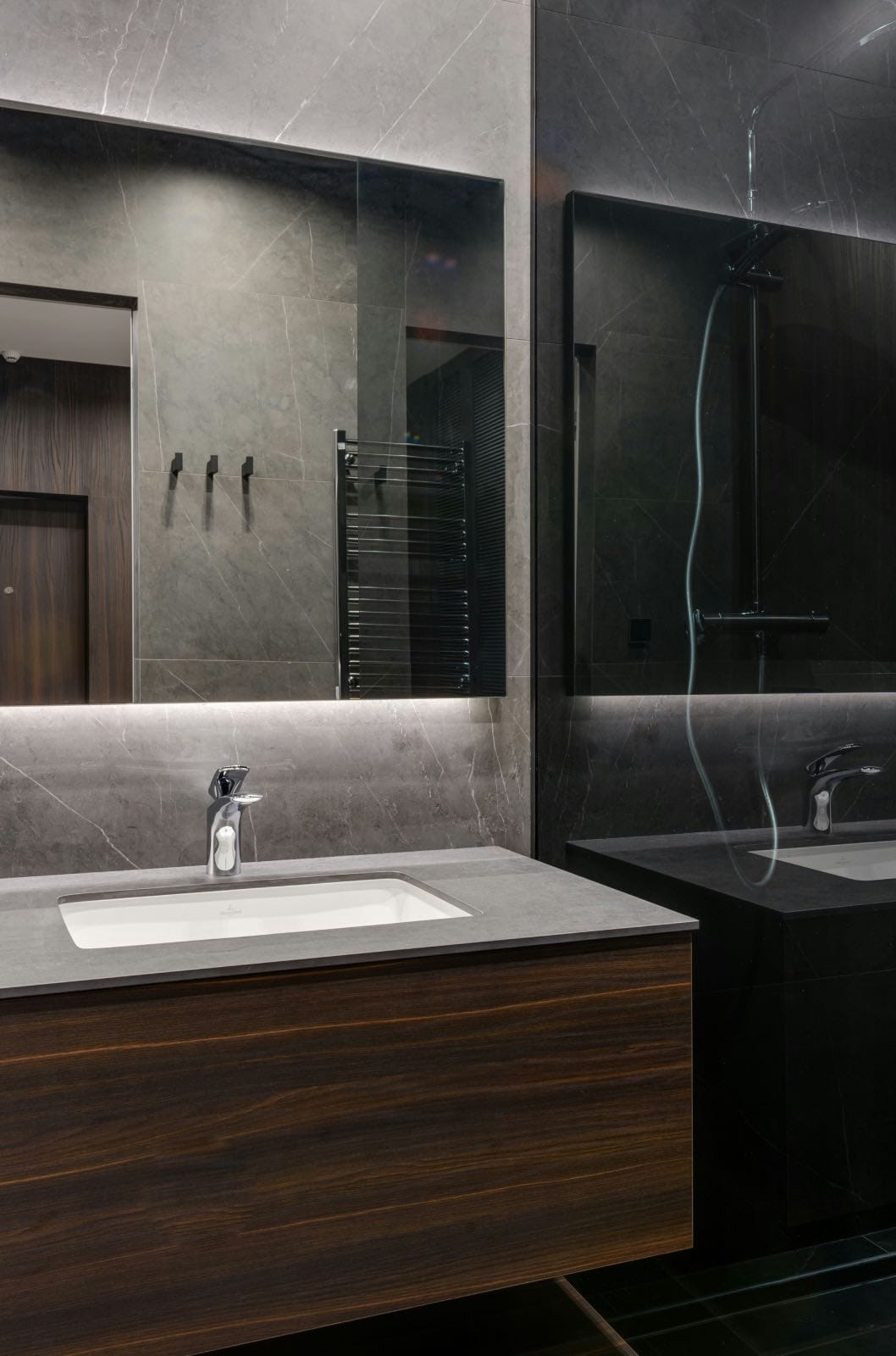modern renovated bathroom with black stone and wood cabinet