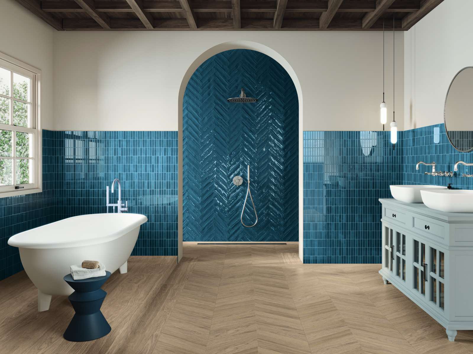 modern bathroom with blue tiles in the shower and wood effect flooring