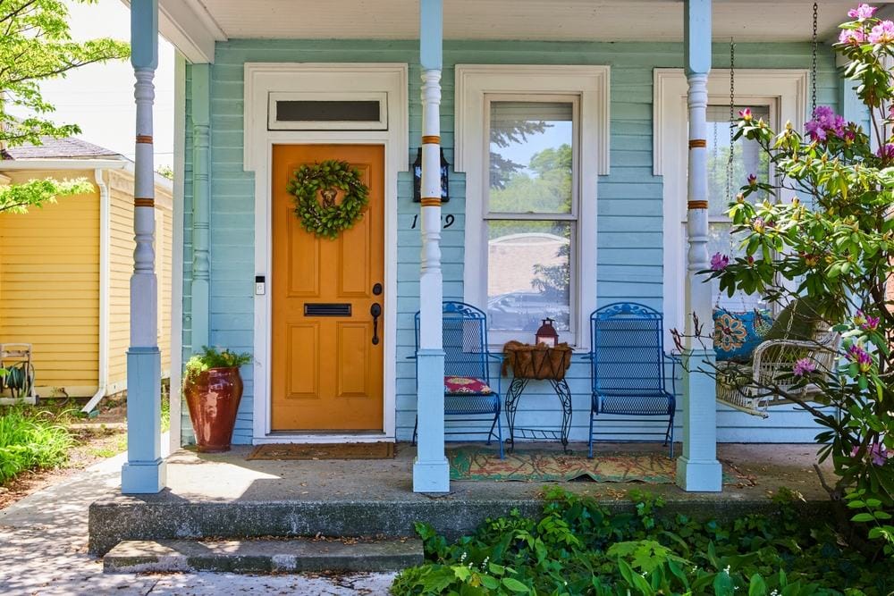 blue home with a small porch