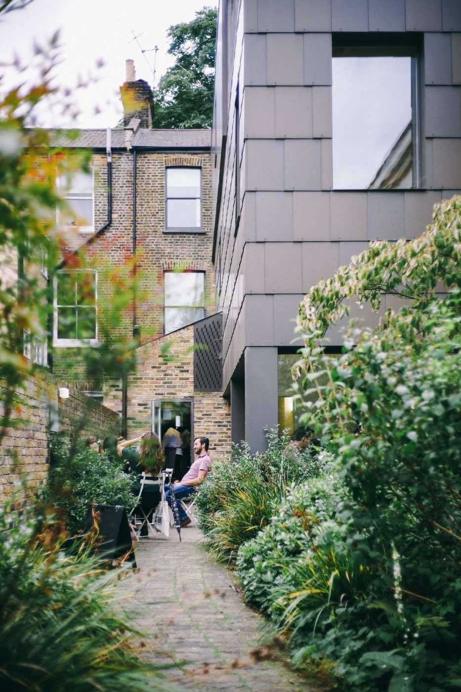 small garden in the city, urban garden with stone flooring and plants