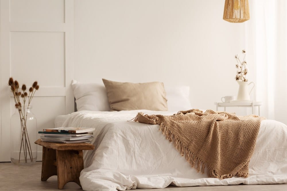 textured brown blankes on creamy sheets