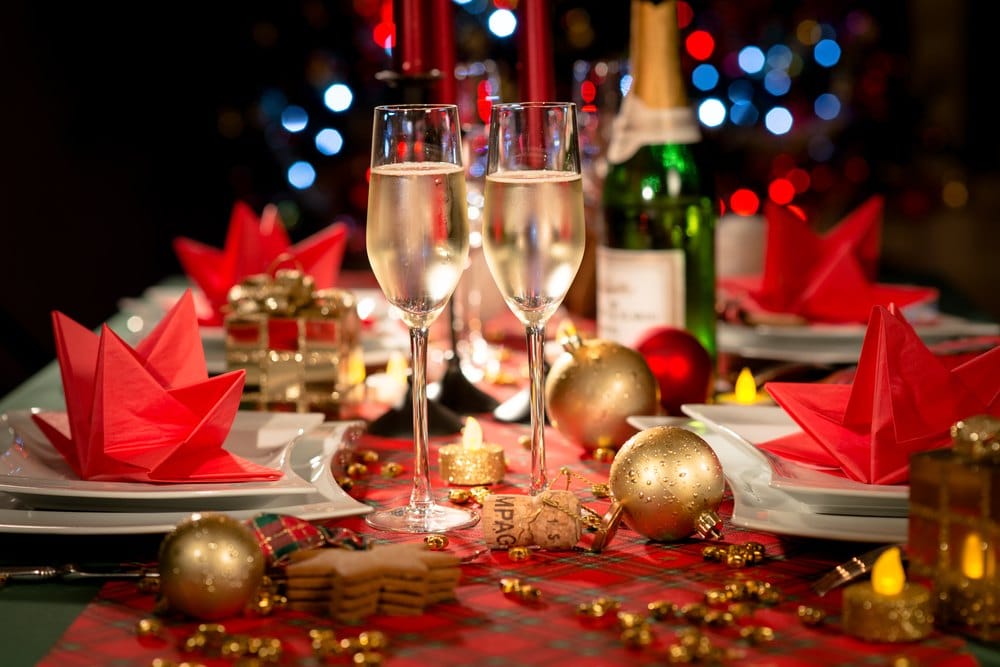 party table with champagne flute with red and golden glitter