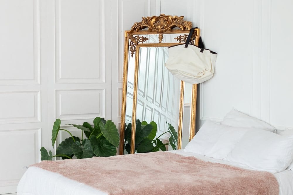 bedroom with gold vintage mirror and wall paneling