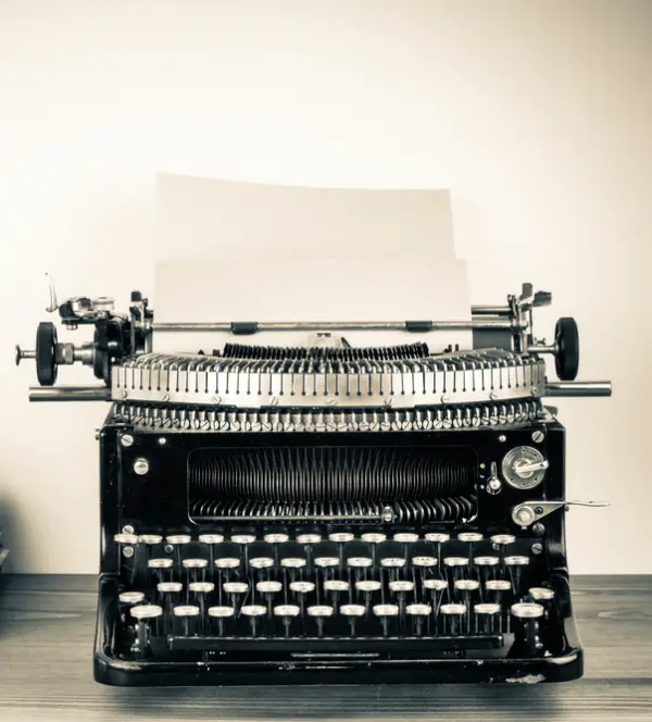 close up of a vintage typewriter with a piece of paper in it