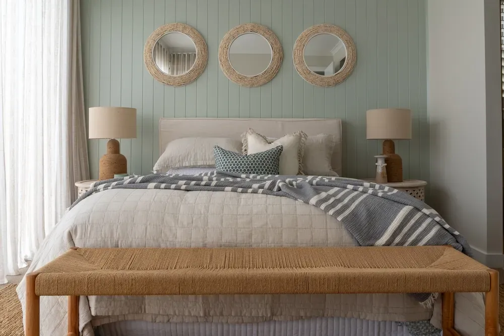 beachy inspired bedroom with wicker and seafoam green wall