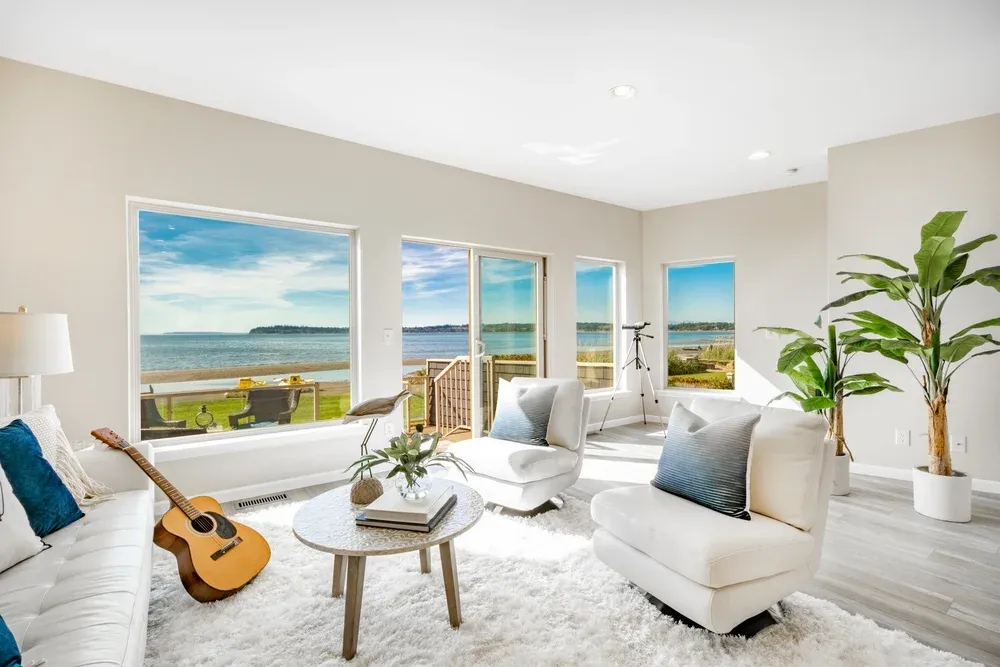 Beachfront condo living room with big windows ocean view