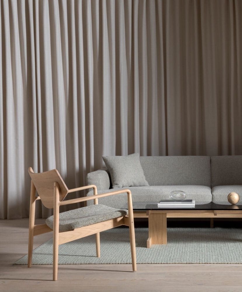 Living room with gray couch and chair made of natural materials