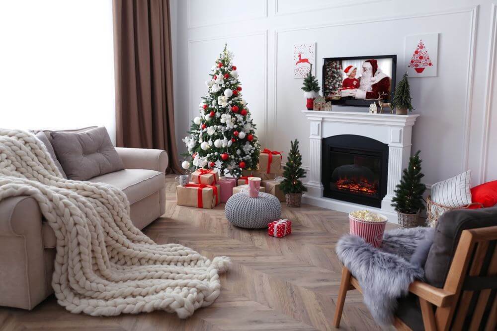 living room with christmas tree and holiday accents