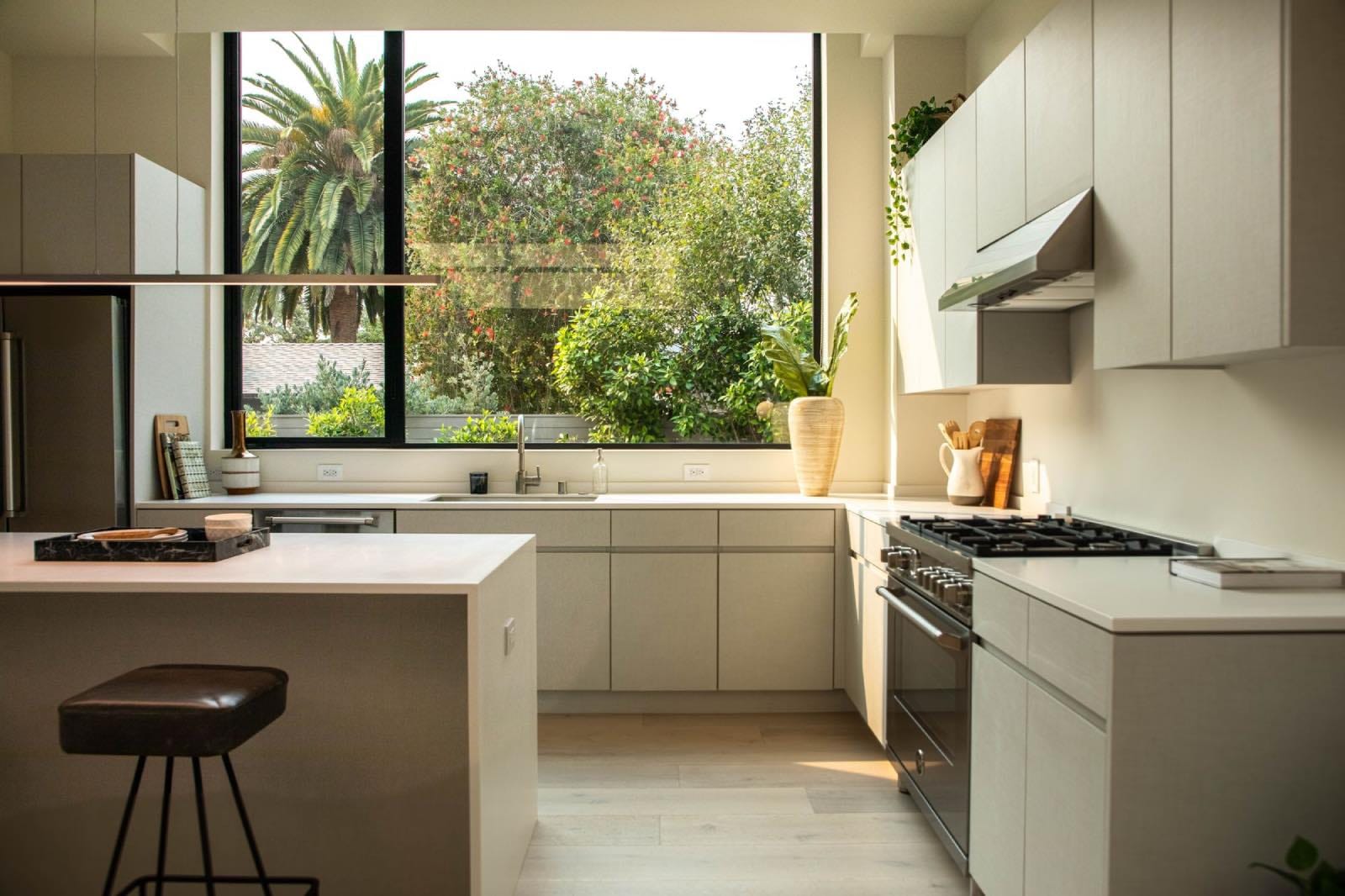 cocina moderna blanca con ventanales, tendencias que dejar atrás en 2024