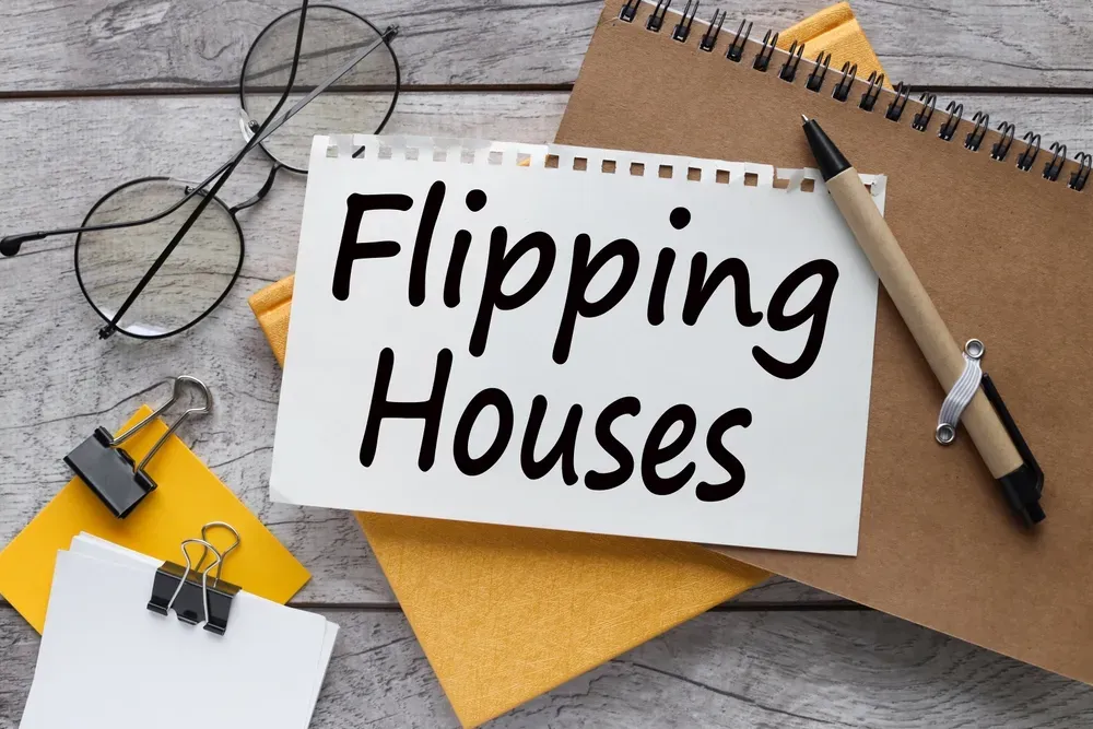 flipping houses sign with folders and notes