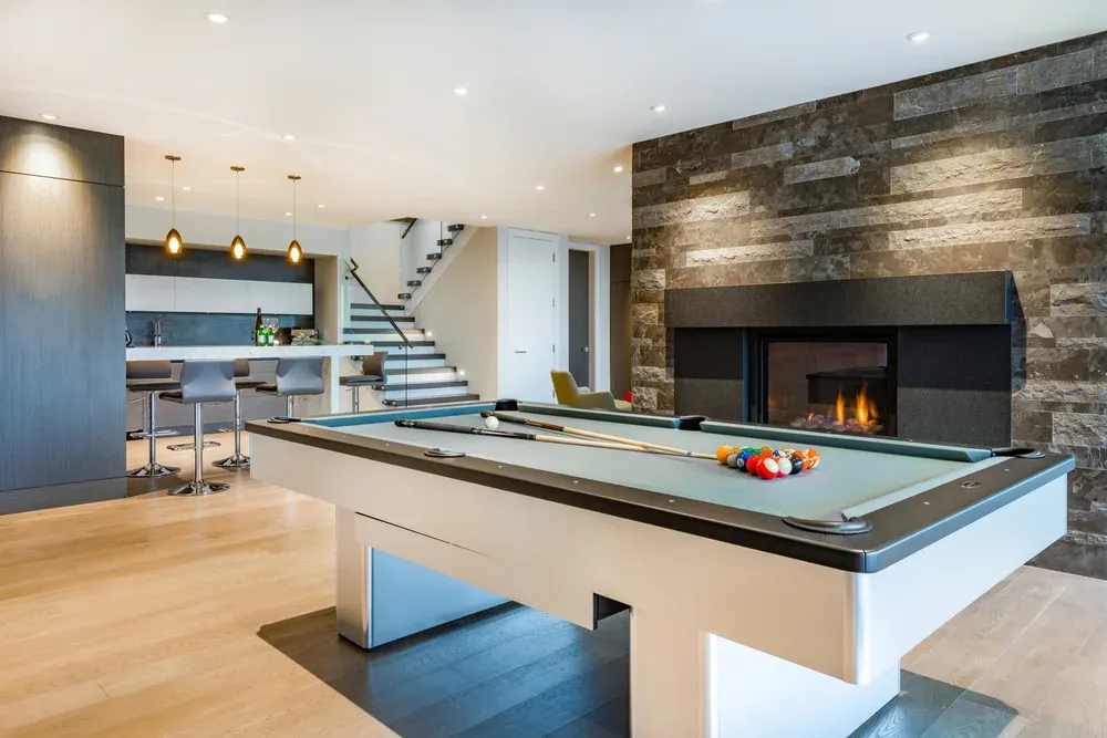pool table in a rec room by a fire place
