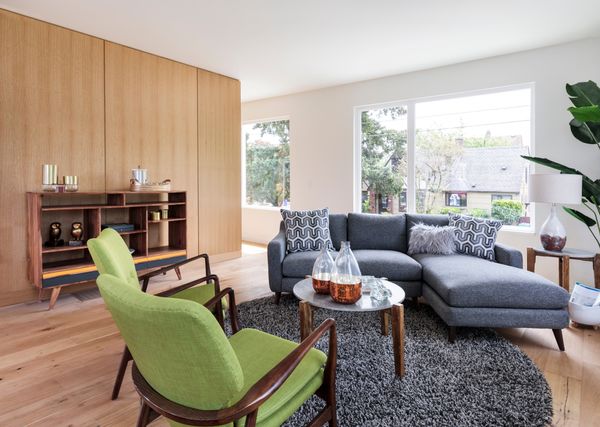 Mid-century living room with green chairs and a blue sofa.