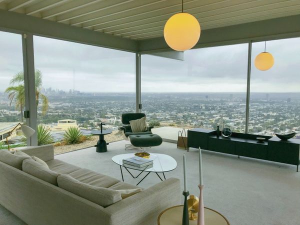 Diseño de interior sofisticado con muebles minimalistas de cristal y grandes ventanales en Los Ángeles