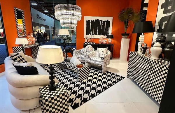 decorated room in black and white with orange walls and crystal chadelier